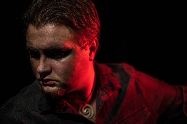 A dramatic portrait of a man with a side light, creating a moody and intense atmosphere.