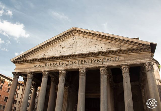 The Pantheon in Rome, Italy, showcases its grand facade and classical architecture under a blue sky.