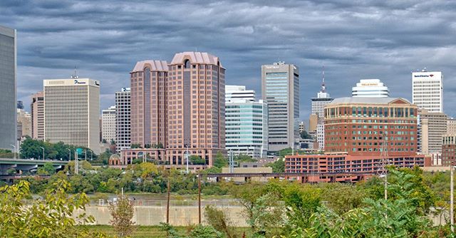 View of a city skyline featuring modern skyscrapers on a cloudy day, showcasing urban architecture and landscape.