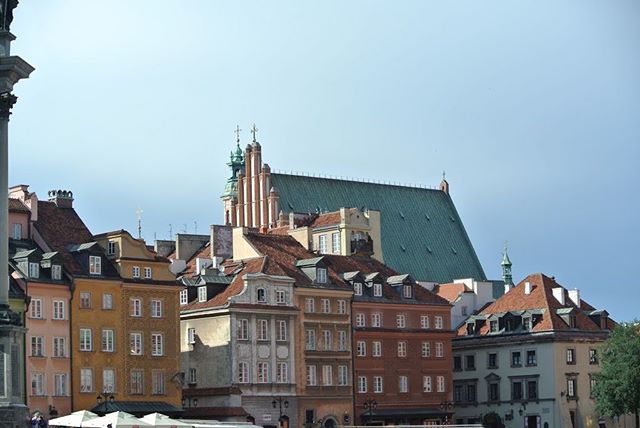 Cityscape view featuring historic buildings and a church under a clear sky, capturing the essence of the urban landscape.