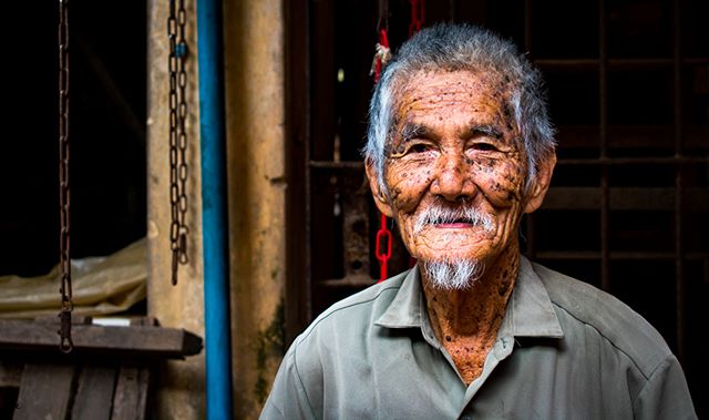 Portrait of an elderly man with weathered skin, embodying a life of experiences and cultural heritage.