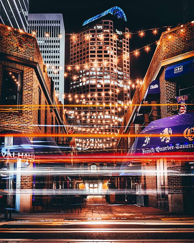 Vibrant city street scene at night with dynamic light trails and towering buildings. A captivating urban landscape.