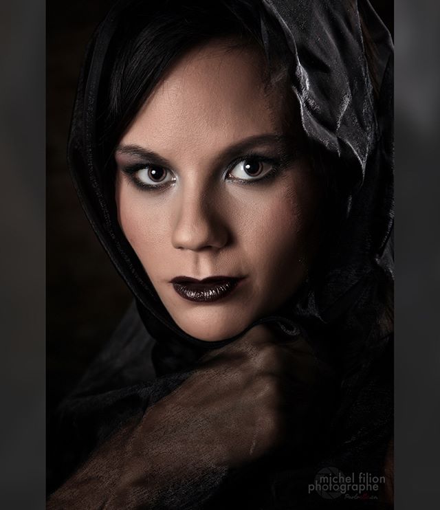 A captivating portrait of a woman in a dark, mysterious editorial style.