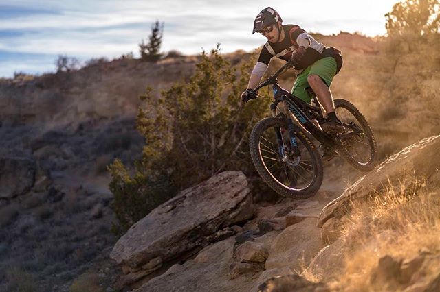A mountain biker rides on a rocky trail, showcasing fitness, sports, and adventure.
