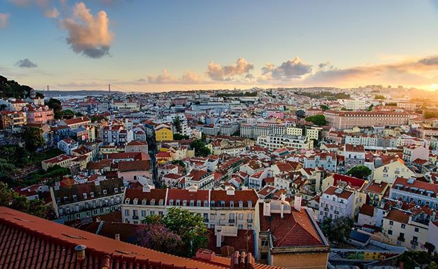 Expansive view of Lisbon featuring its buildings and landmarks under a serene sky. 
