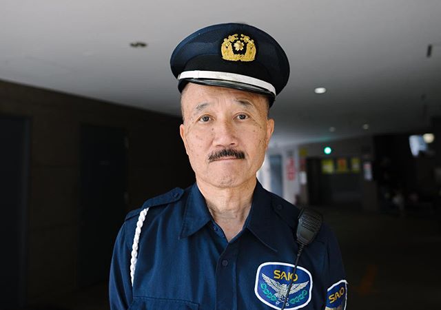 A uniformed security guard poses indoors, conveying professionalism and vigilance.