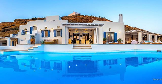 A luxury villa with a pool blends modern design with serene vibes, perfect for travel and real estate marketing.
