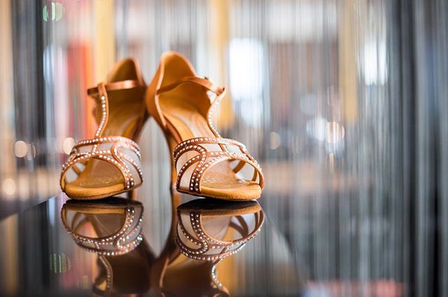 Elegant high heels are reflected on a glossy surface, perfect for fashion or bridal themes.