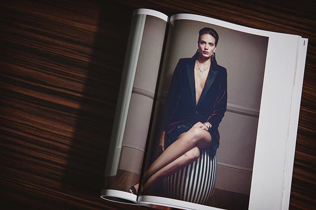 A stylish woman models jewelry in an elegant fashion editorial spread in a magazine, perfect for advertising.