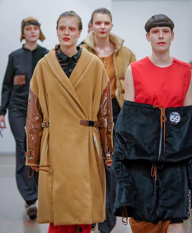 Models showcase avant-garde designs on the runway in a modern fashion show, editorial style.