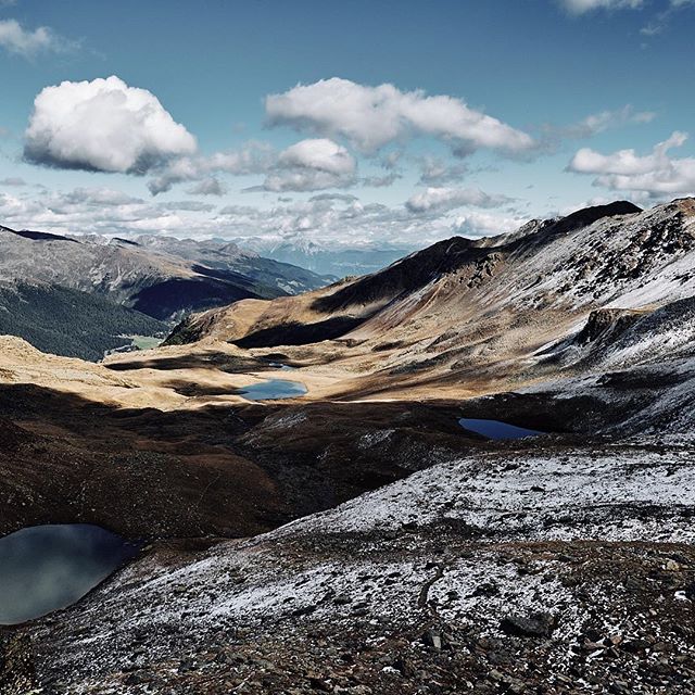 Scenic view of mountain landscape with lakes and snow under a cloudy sky. Perfect for travel and tourism campaigns.