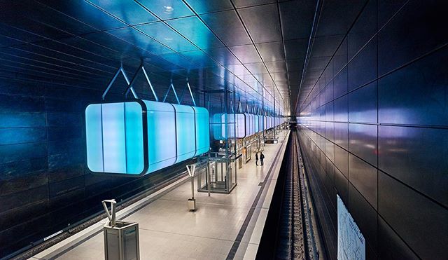 A modern subway station platform features unique lighting and a sleek, minimalist design for urban commuters.