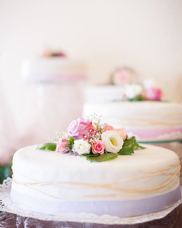 Elegant wedding cakes decorated with fresh flowers create a romantic atmosphere.