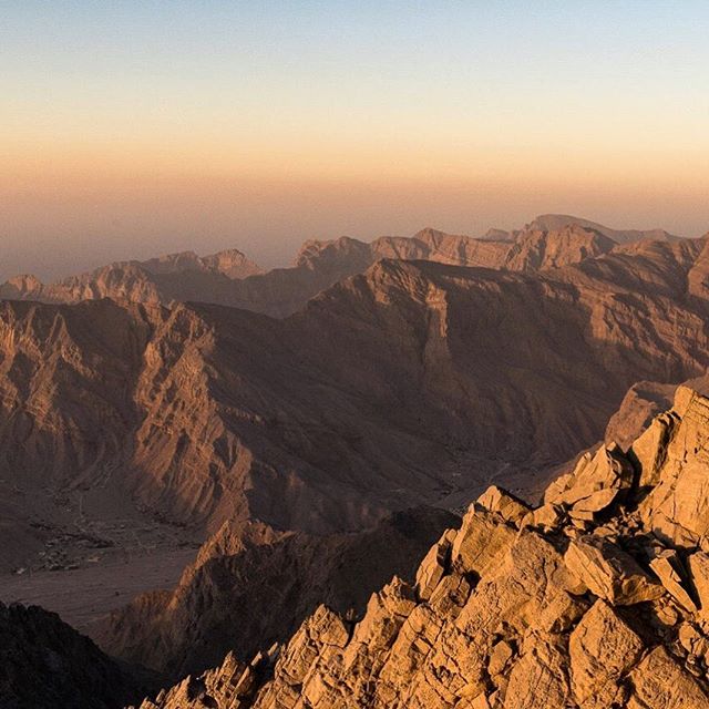 A scenic view of a majestic mountain range at sunset, perfect for travel and nature themes.