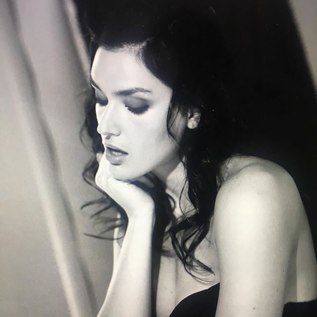 A black and white portrait of a brunette woman with soft lighting and a sensual, dreamy mood. Great for editorial or beauty campaigns.