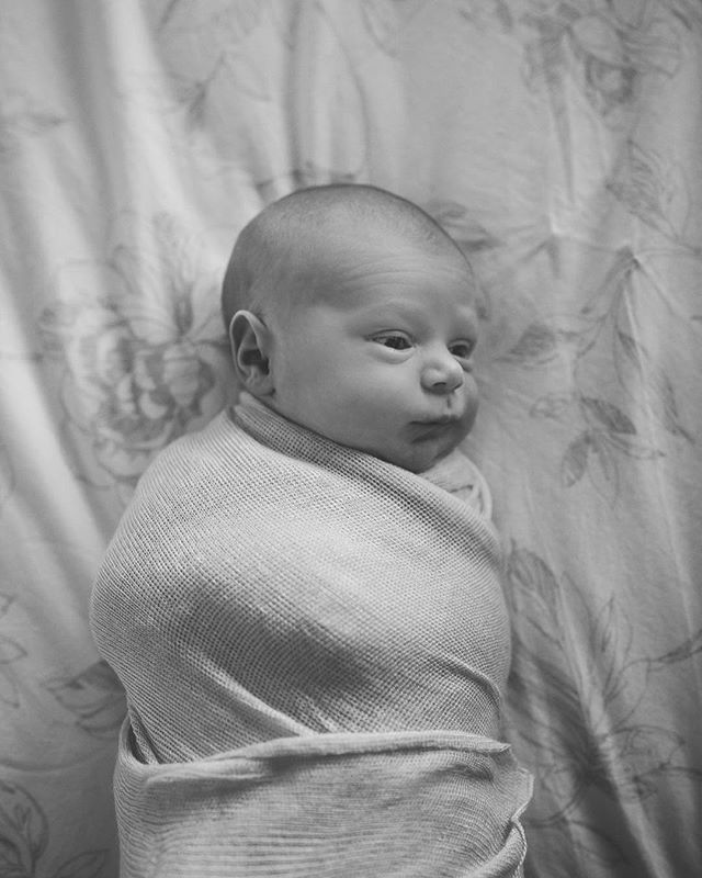 A newborn baby swaddled in a blanket, resting peacefully. Perfect for parenting or baby product advertisement.