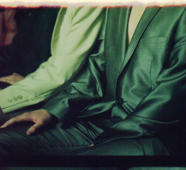 A photo of two men wearing suits, possibly at a business meeting or formal event.