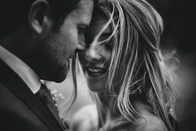 A loving couple shares an intimate moment, showcasing their deep connection and affection on their wedding day.