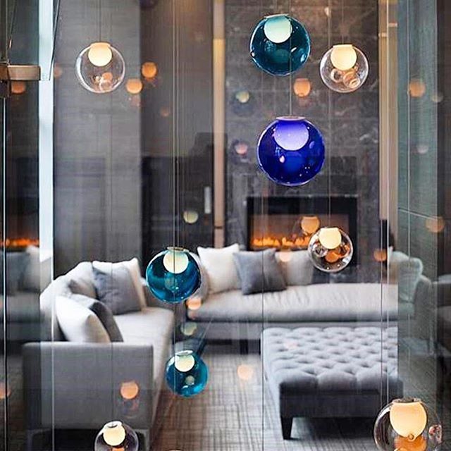 A modern living room featuring hanging glass orbs, creating a serene and elegant ambiance.