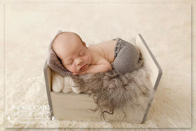 A newborn baby peacefully sleeps in a cozy bed, perfect for baby product advertisements and newborn photography promotions.