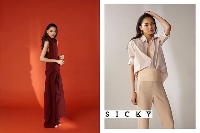 Two women model elegant and modern clothing in a minimalist studio fashion editorial.
