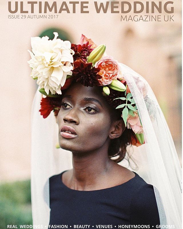 A bride with a floral headpiece and veil poses for a wedding magazine cover.