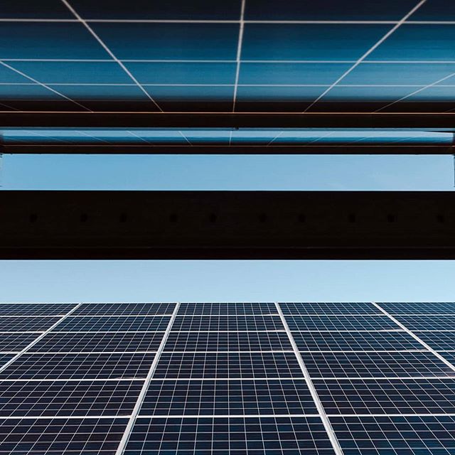 Clean, low angle shot of solar panels generating power from the sun, for sustainable energy solutions.
