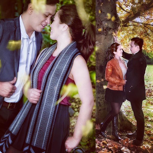 A couple shares an intimate moment surrounded by the beauty of autumn foliage in a park setting.
