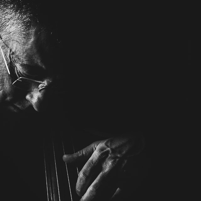 A monochrome close-up of a musician playing an instrument, showcasing artistic expression and musical talent.