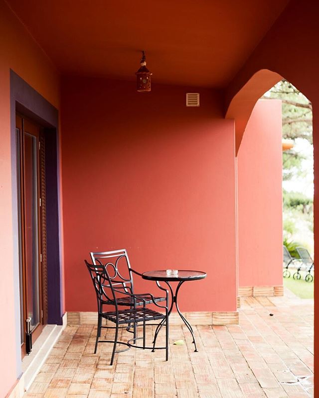 A cozy patio with a table and chairs offers a relaxing outdoor space.