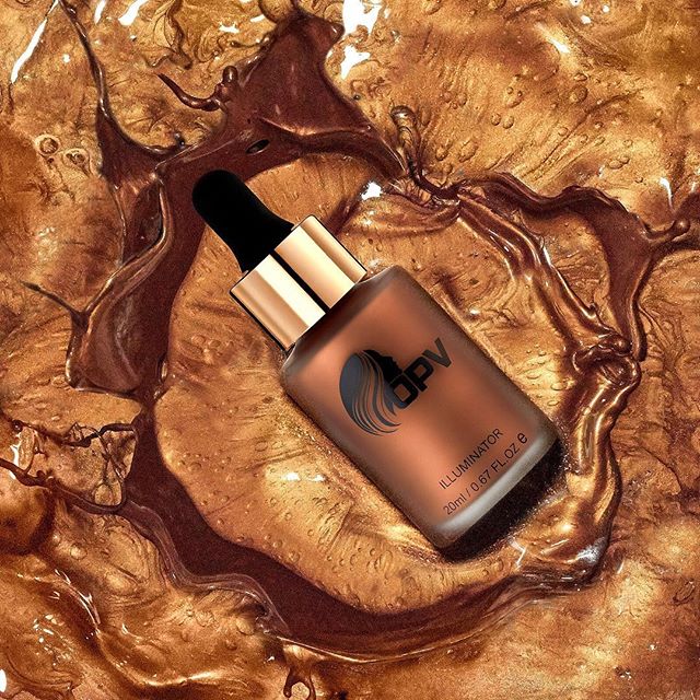 A bottle of OPV illuminator sits on a gold textured background, perfect for beauty and cosmetics advertising.