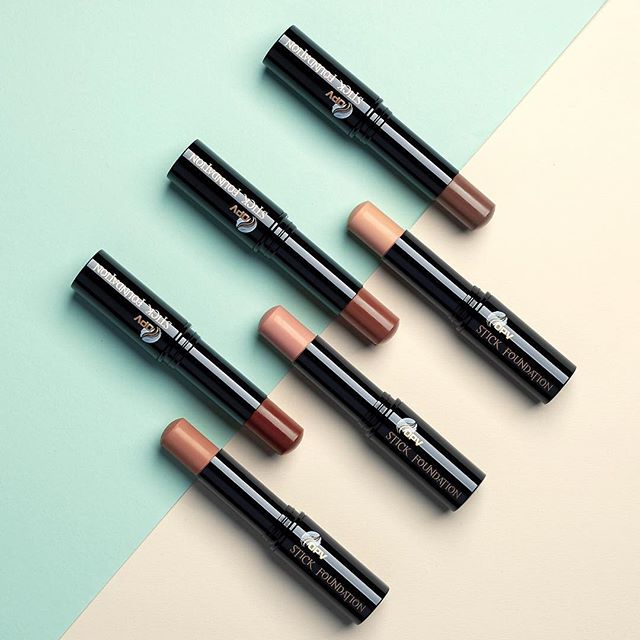 Various shades of foundation sticks are displayed for beauty and makeup promotions.