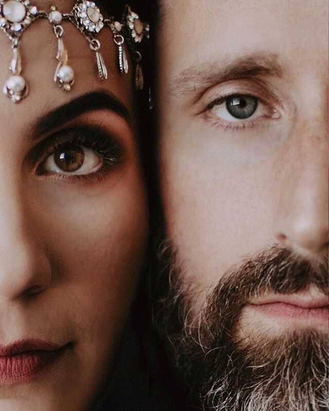 An intimate portrait of a man and woman, their faces closely aligned showing a deep connection and soft affection.