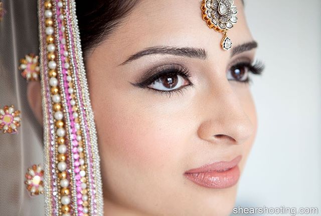 A beautiful Indian bride showcases elegant makeup and traditional jewelry for a luxury bridal campaign.