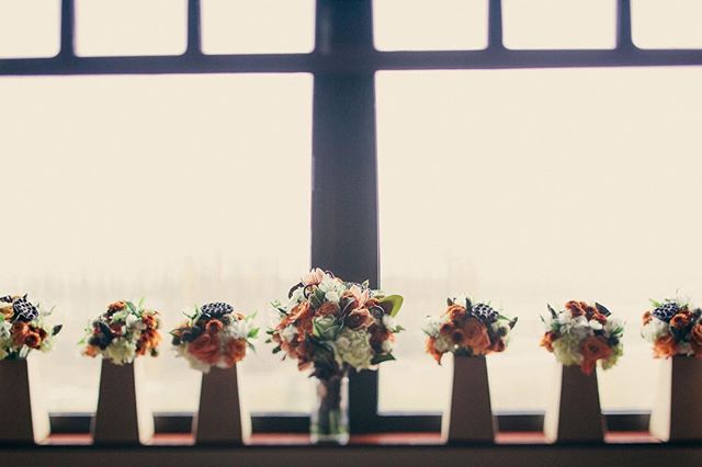 Bridal bouquets displayed in front of a window for a wedding celebration.