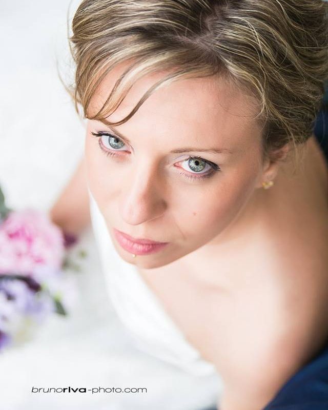 A close-up, high-angle shot of a woman with soft lighting.