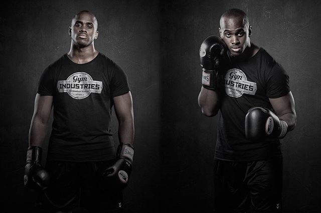 Two determined black men in gym gear strike a pose, promoting fitness and boxing.