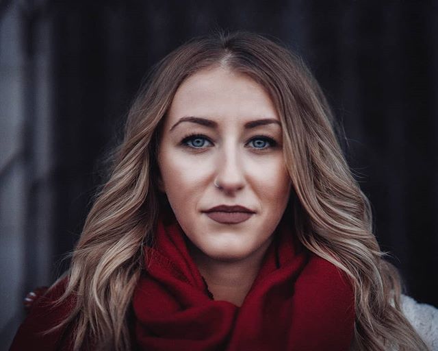 Portrait of a woman with blue eyes and a red scarf, creating a striking and intense image.