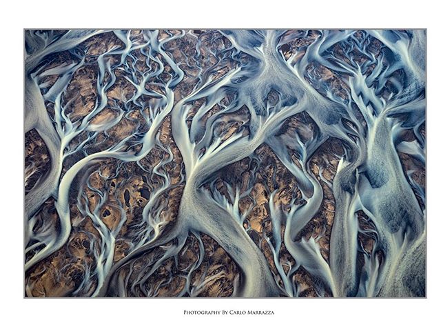 Aerial view of braided river system in Iceland, showcasing the intricate patterns of nature's waterways.