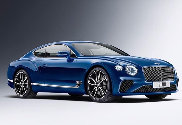 A luxurious blue Bentley Continental GT coupe showcasing its elegant design and powerful presence.