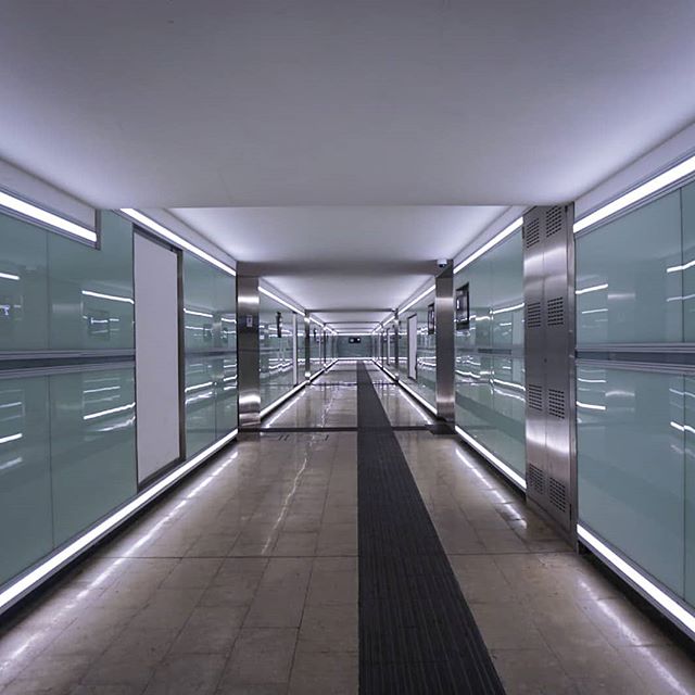 A well-lit, modern hallway with clean lines creates a sense of calm and order. The space is uncluttered and minimalist in design.