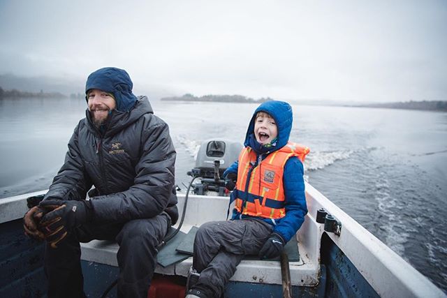 Father and son enjoy a boat ride on a lake, creating memorable moments in the outdoors.