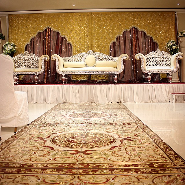 Elegantly decorated stage with ornate seating, perfect for weddings and special event backdrops.