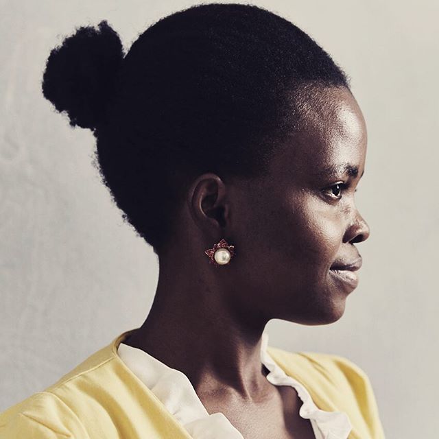 A sophisticated African American woman gazes calmly in a studio portrait.