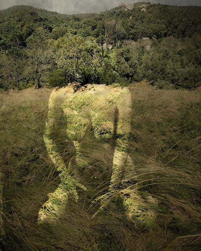 A woman's form blends with the landscape, creating a surreal fusion of nature and the human body.
