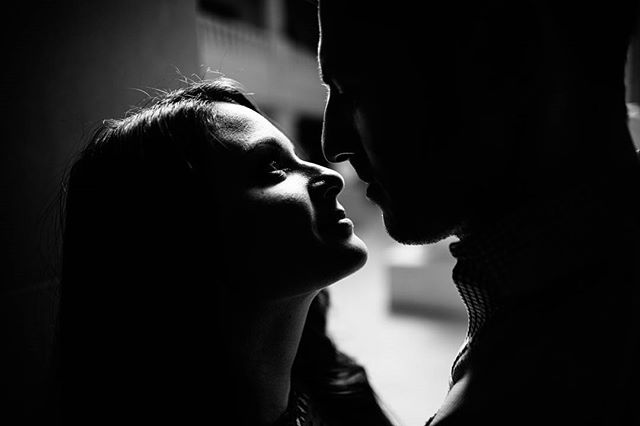 An intimate moment captured in black and white, featuring a couple in a close embrace.