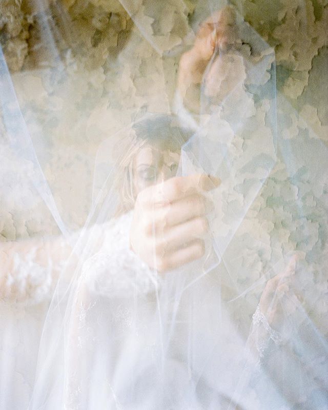 A dreamy image of a bride with a veil, capturing a soft and intimate moment in a vintage style.
