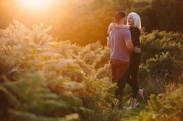 A loving couple embraces in a field at sunset, bathed in warm, dreamy light. Perfect for romantic or lifestyle content.