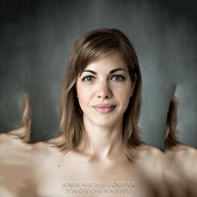 A captivating portrait of a woman against a gray backdrop, merging artistry and modern aesthetics.