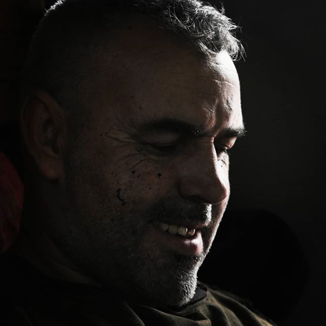 Close-up portrait of a mature man smiling in soft, natural light, ideal for lifestyle content.